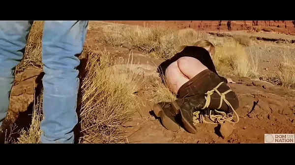 Big-ass blonde gets her asshole whipped, then gets rough anal sex in dirt and piss -- a real BDSM session outdoors in the Western USA with Rebel Rhyder